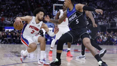 Apr 19, 2026; Detroit, Michigan, USA; Detroit Pistons guard Cade Cunningham (2) dribbles defended by Orlando Magic forward Paolo Banchero (5) in the second half during the 2026 NBA Playoffs at Little Caesars Arena. Mandatory Credit: Rick Osentoski-Imagn Images