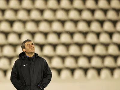 FILE PHOTO: Steaua Bucharest head coach Gheorghe Hagi looks at the sky as it rains during a practice session in Prague September 18, 2007. Steaua will play Slavia in a Champions League Group H soccer match on Wednesday in Prague. REUTERS/David W Cerny (CZECH REPUBLIC)/File Photo