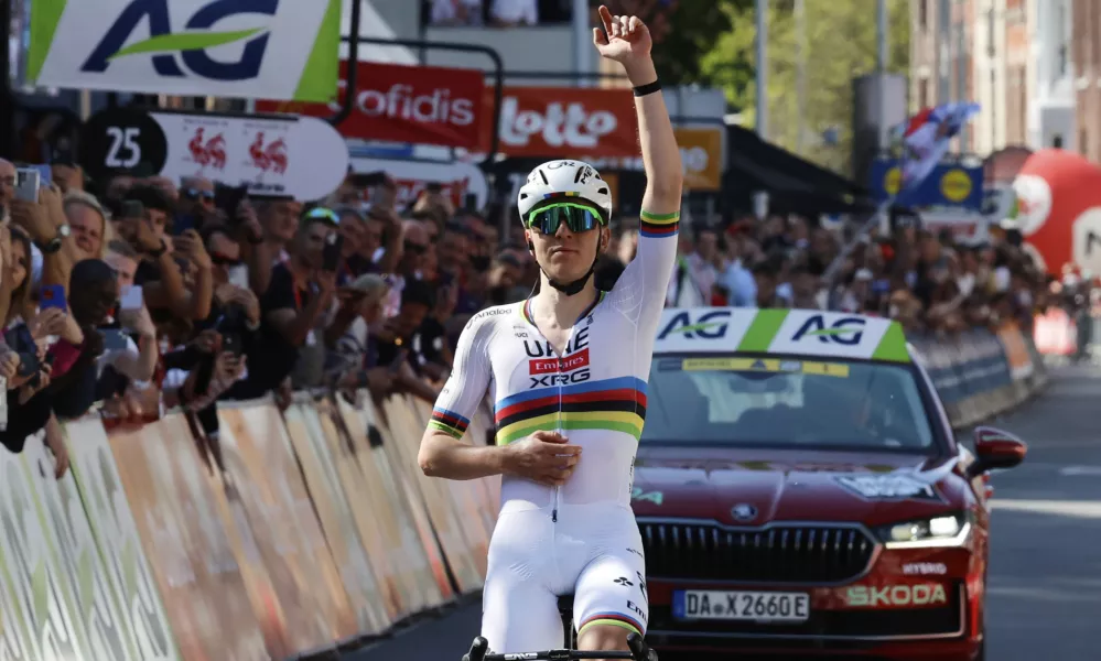 Slovenia's Tadej Pogacar of the UAE Team Emirates URG team crosses the finish line to win the Belgian cycling classic and UCI World Tour race Liege Bastogne Liege, in Liege, Belgium, Sunday, April 27, 2025. (AP Photo/Geert Vanden Wijngaert)