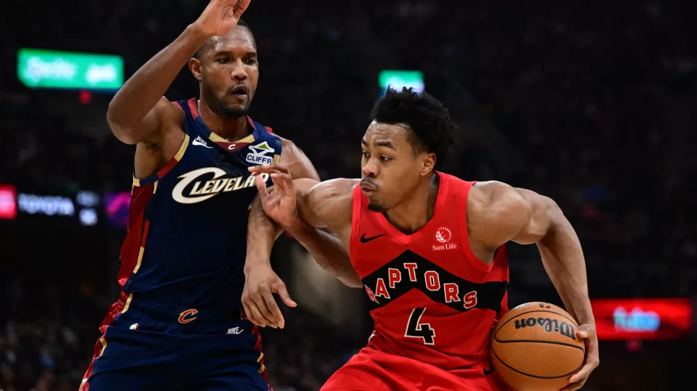 Apr 20, 2026; Cleveland, Ohio, USA; Toronto Raptors forward Scottie Barnes (4) drives on Cleveland Cavaliers center Evan Mobley (4) during the second half during game two of the first round of the 2026 NBA Playoffs at Rocket Arena. Mandatory Credit: David Dermer-Imagn Images