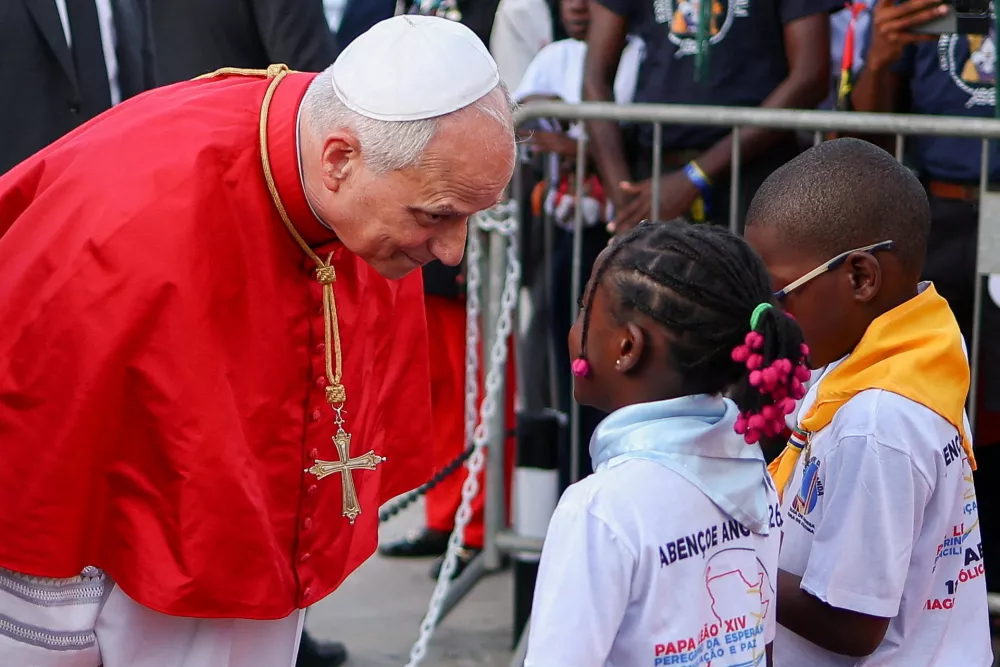 Pope Leo XIV greets children as he attends a meeting with bishops, priests, consecrated men and women and pastoral workers at the Parish of Our Lady of Fatima, in Luanda, Angola, April 20, 2026. REUTERS/Guglielmo Mangiapane   TPX IMAGES OF THE DAY