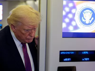 U.S. President Donald Trump listens as he talks to members of the media aboard Air Force One en route to Joint Base Andrews, Maryland, U.S., April 17, 2026. REUTERS/Evan Vucci