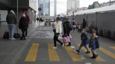 A refugee woman with children walk at the central train station in Warsaw, Poland, Thursday, April 7, 2022. (AP Photo/Czarek Sokolowski)