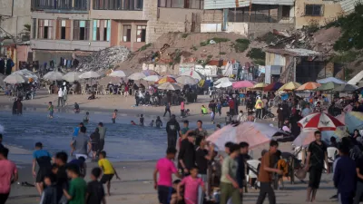 Palestinians gather by the sea on Gaza City's beach, Sunday, April 19, 2026. (AP Photo/Jehad Alshrafi)