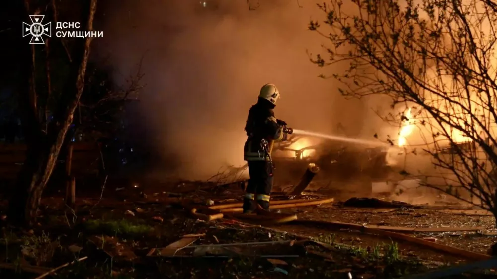 A firefighter works at a site of Russian strikes, amid Russia's attack on Ukraine, in Sumy, Ukraine, in this screen grab taken from a handout video released on April 21, 2026.   State Emergency Service Of Ukraine In Sumy Region/Handout via REUTERS  THIS IMAGE HAS BEEN SUPPLIED BY A THIRD PARTY. MANDATORY CREDIT. OVERLAYS FROM SOURCE. Verification:- - Building facades, windows and benches matched file images and corroborating images from police - Date not verified but no older version of the video was found posted online before April 21, 2026 - Sumy region governor Oleh Hryhorov confirmed in a statement posted on April 21 that 15 people were wounded in the night attack in Sumy