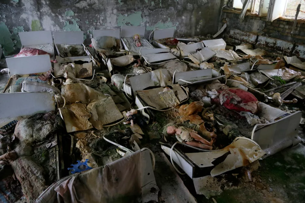 FILE - Beds sit in a room of an abandoned kindergarten in the deserted town of Pripyat, Ukraine, Nov. 27, 2012, which housed Chernobyl nuclear power plant workers and their families. (AP Photo/Efrem Lukatsky, File)