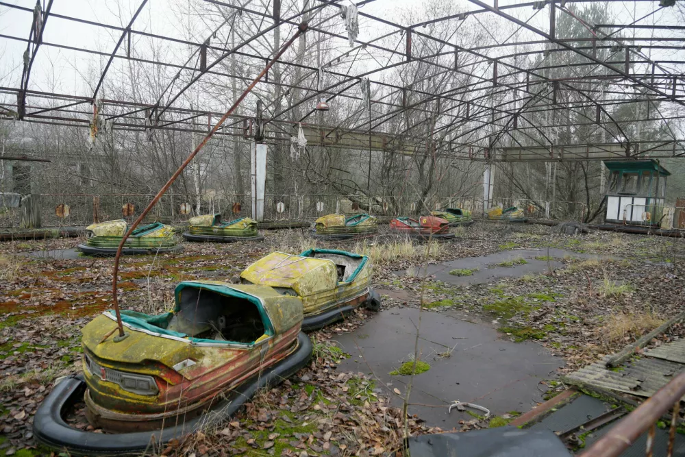 FILE - Bumper cars sit in a playground in the deserted town of Pripyat, Ukraine, Nov. 27, 2012, once home to people whose lives were connected to the nearby Chernobyl nuclear power plant. (AP Photo/Efrem Lukatsky, File)