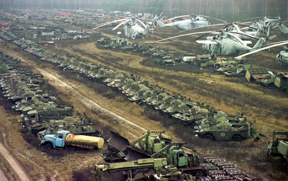 FILE - About 1,350 Soviet military helicopters, buses, bulldozers, tankers, transporters, fire engines and ambulances, all highly contaminated with radiation, sit abandoned in a junkyard, in Chernobyl, Ukraine, Nov. 10, 2000, after being used in cleanup operations following the 1986 explosion in the Chernobyl nuclear power plant. (AP Photo/Efrem Lukatsky, File)