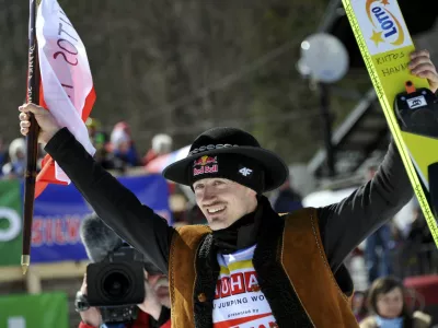 Adam Malysz of Poland greets spectators before the awarding ceremony for the overall winners of the FIS World Cup Ski Jumping 2011 in Planica, Slovenia March 20, 2011. Malysz gained third position.  REUTERS/Srdjan Zivulovic (SLOVENIA - Tags: SPORT SKI JUMPING)