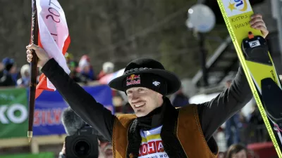 Adam Malysz of Poland greets spectators before the awarding ceremony for the overall winners of the FIS World Cup Ski Jumping 2011 in Planica, Slovenia March 20, 2011. Malysz gained third position.  REUTERS/Srdjan Zivulovic (SLOVENIA - Tags: SPORT SKI JUMPING)