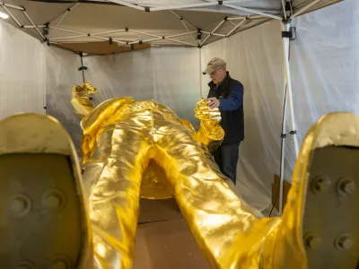 Alan Cottrill inspects the 15-foot tall golden Trump statue that he designed in Zanesville, Ohio, Jan. 29, 2026. At 15 feet tall, the statue of President Trump, mounted on its 7,000-pound pedestal, is about the height of a two-story building -- a giant effigy cast in bronze and finished with a thick layer of gold leaf.,Image: 1071895357, License: Rights-managed, Restrictions:, Model Release: no