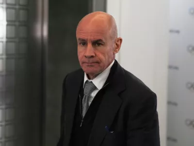 FILE - Candidate to the presidency of the International Olympic Committee Johan Eliasch arrives at the mixed zone during a break of the 144th session, which will elect the new IOC President, in Costa Navarino, western Greece, March 19, 2025. (AP Photo/Thanassis Stavrakis, File)