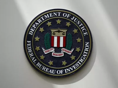 FILE - The FBI seal is pictured in Omaha, Neb., Aug. 10, 2022. A man who federal agents say tried to board a plane in New Jersey with three guns, including a semi-automatic rifle, and a fake law-enforcement ID is in federal custody and facing two charges. Seretse Clouden, who has a prior weapon-related conviction, is charged with possession of a firearm by a felon and having a fraudulent ID, according to a complaint posted Monday, Feb. 27, 2023. (AP Photo/Charlie Neibergall, File)