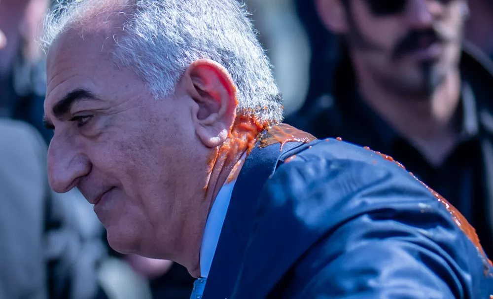 Iran's Reza Pahlavi, exiled son of Shah Reza Pahlavi, reacts after he was attacked with a red fluid following a news conference in Berlin, Germany, Thursday, April 23, 2026. (Michael Kappeler/dpa via AP)