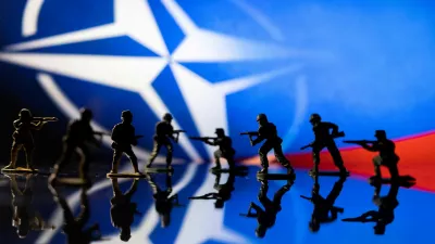 FILE PHOTO: Army soldier figurines are displayed in front of the NATO logo and Russian flag colours background in this illustration taken, February 13, 2022. REUTERS/Dado Ruvic/Illustration/File Photo