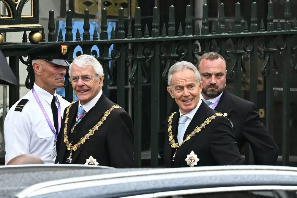 Former UK Prime Ministers John Major and Tony Blair arrive at Westminster Abbey in central London on May 6, 2023, ahead of the coronations of Britain's King Charles III and Britain's Camilla, Queen Consort. The set-piece coronation is the first in Britain in 70 years, and only the second in history to be televised. Charles will be the 40th reigning monarch to be crowned at the central London church since King William I in 1066. Outside the UK, he is also king of 14 other Commonwealth countries, including Australia, Canada and New Zealand. Camilla, his second wife, will be crowned queen alongside him, and be known as Queen Camilla after the ceremony.,Image: 774162243, License: Rights-managed, Restrictions:, Model Release: no