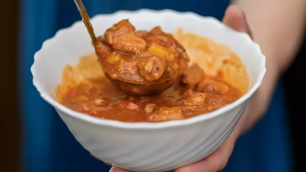 Ladle the meat stew with vegetables into a bowl