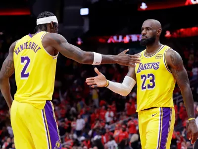 Los Angeles Lakers forwards Jarred Vanderbilt (2) and LeBron James (23) celebrate after their overtime win against the Houston Rockets in Game 3 of a first-round NBA playoffs basketball series Friday April 24, 2026, in Houston. (AP Photo/Michael Wyke)
