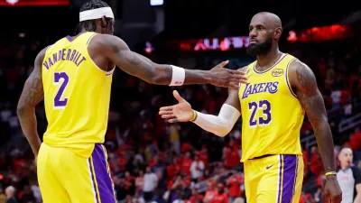 Los Angeles Lakers forwards Jarred Vanderbilt (2) and LeBron James (23) celebrate after their overtime win against the Houston Rockets in Game 3 of a first-round NBA playoffs basketball series Friday April 24, 2026, in Houston. (AP Photo/Michael Wyke)