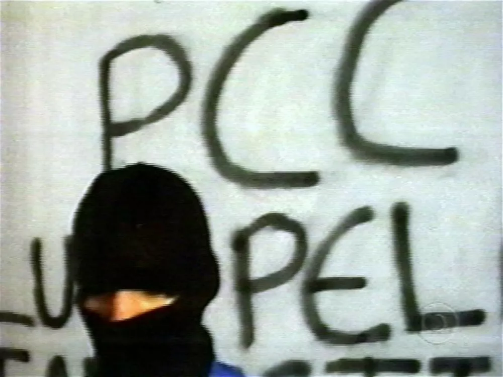 This TV grab is part of the video exhibited by Globo TV network in last sunday early morning as an imposition to free Brazilian TV reporter Guilherme Portanova, in Sao Paulo, Brazil. Portanova was set free by the Primeiro Comando de la Capital (PCC) gang after his television network on Sunday met the kidnappers' demands by broadcasting a three-and-a-half minute videotape they made. In the videotape, a hooded man representing the much-feared criminal group -- whose name in English means First Capital Command -- criticizes Brazil's penal system and demands better conditions in Sao Paolo's prisons. Portanova, who was freed early Monday from the trunk of a car parked near TV Globo's Sao Paolo offices, said he was treated well by his captors. PHOTO,Image: 18847631, License: Rights-managed, Restrictions:, Model Release: no