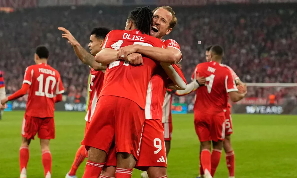 Bayern's Michael Olise celebrates with Harry Kane after scoring his side's fourth goal uring the Champions League quarterfinal second leg soccer match between Bayern Munich and Real Madrid in Munich, Germany, Wednesday, April 15, 2026. (AP Photo/Matthias Schrader)