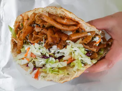 FILED - 19 February 2018, Brandenburg, Frankfurt an der Oder: A person holds a Doner Kebab. Survey: Doner kebab topples currywurst as Germany's ruling fast food. Photo: Patrick Pleul/dpa-Zentralbild/ZB