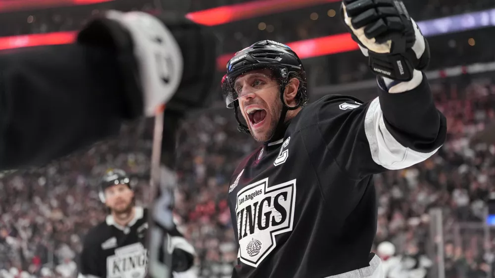Los Angeles Kings' Anze Kopitar (11) celebrates a goal by Joel Edmundson against the Colorado Avalanche during the second period of Game 4 in the first round of an NHL hockey Stanley Cup playoff series Sunday, April 26, 2026, in Los Angeles. (AP Photo/Scott Strazzante)
