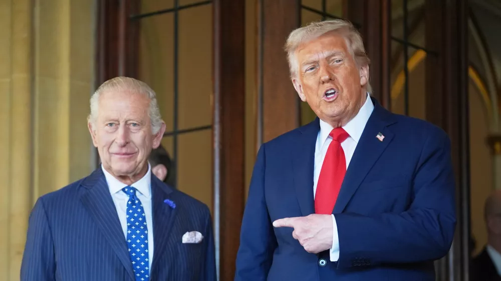 FILE - President Donald Trump gestures next to Britain's King Charles III before leaving Windsor Castle, Windsor, England, Sept. 18, 2025. (AP Photo/Evan Vucci, file)