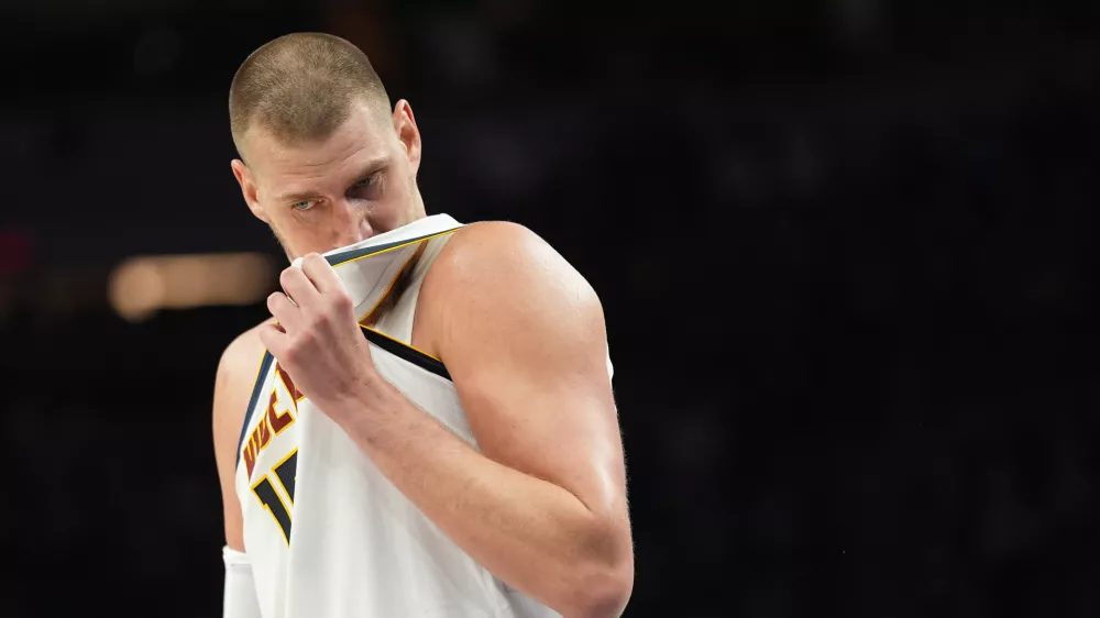 Denver Nuggets center Nikola Jokic (15) waits for play to resume during the second half in Game 3 of a first-round NBA basketball playoff series against the Minnesota Timberwolves, Thursday, April 23, 2026, in Minneapolis. (AP Photo/Abbie Parr)