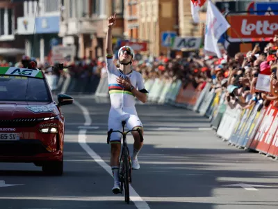Slovenia's Tadej Pogacar of the UAE Team Emirates crosses the finish line to win the Belgian cycling classic and UCI World Tour race Liege Bastogne Liege, in Liege, Belgium, Sunday, April 26, 2026. (AP Photo/Geert Vanden Wijngaert)