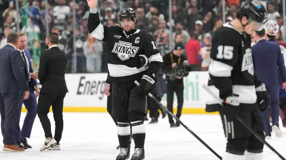 After the final game of his career, Los Angeles Kings' Anze Kopitar, center, waves to the fans following Game 4 in the first round of an NHL hockey Stanley Cup playoff series against the Colorado Avalanche, Sunday, April 26, 2026, in Los Angeles. (AP Photo/Scott Strazzante)