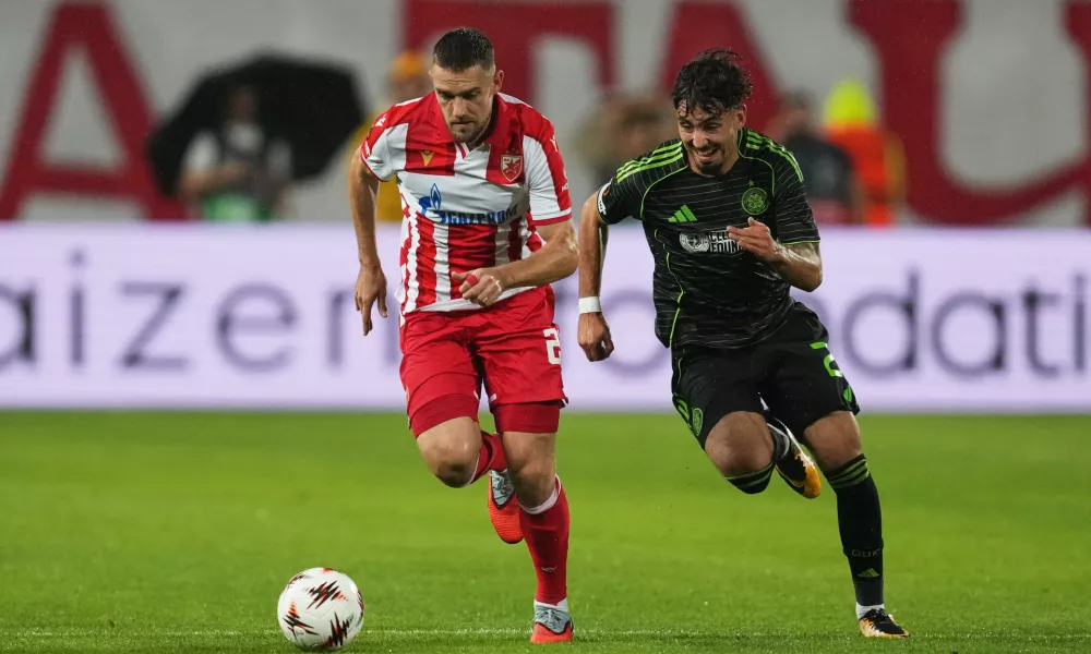 Red Star's Timi Max Elsnik, left, challenges for the ball with Celtic's Sebastian Tounekti during the Europa League soccer match between Red Star and Celtic at the Rajko Mitic Stadium in Belgrade, Serbia, Wednesday, Sept. 24, 2025. (AP Photo/Darko Vojinovic)