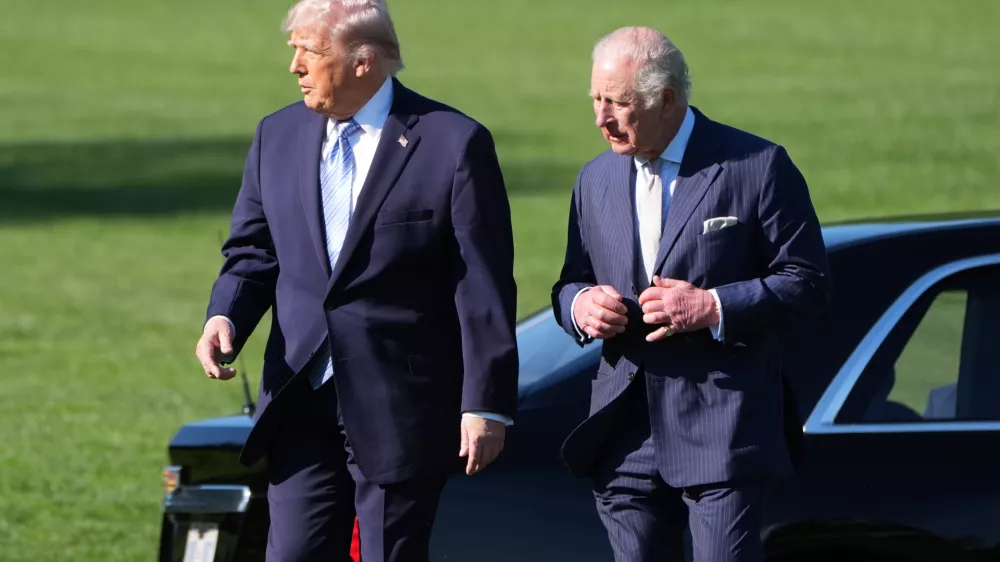 President Donald Trump and Britain's King Charles III arrive to look at the White House garden and bee hive on the South Lawn of the White House, Monday, April 27, 2026, in Washington. (AP Photo/Alex Brandon, Pool)