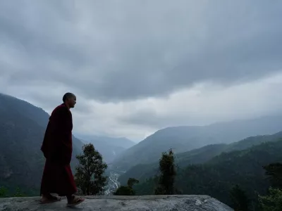 A monk walks by the Jigaon monastery in Sherdukpen village in West Kameng, Arunachal Pradeshin, India, Sunday, April 26, 2026. (AP Photo/Anupam Nath)