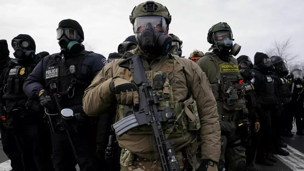 Members of U.S. Customs and Border Protection (CBP) and other law enforcement officials stand guard, in front of the Bishop Henry Whipple Federal Building, during a protest more than a week after an ICE agent fatally shot Renee Nicole Good, in Minneapolis, Minnesota, U.S., January 17, 2026. REUTERS/Seth Herald TPX IMAGES OF THE DAY