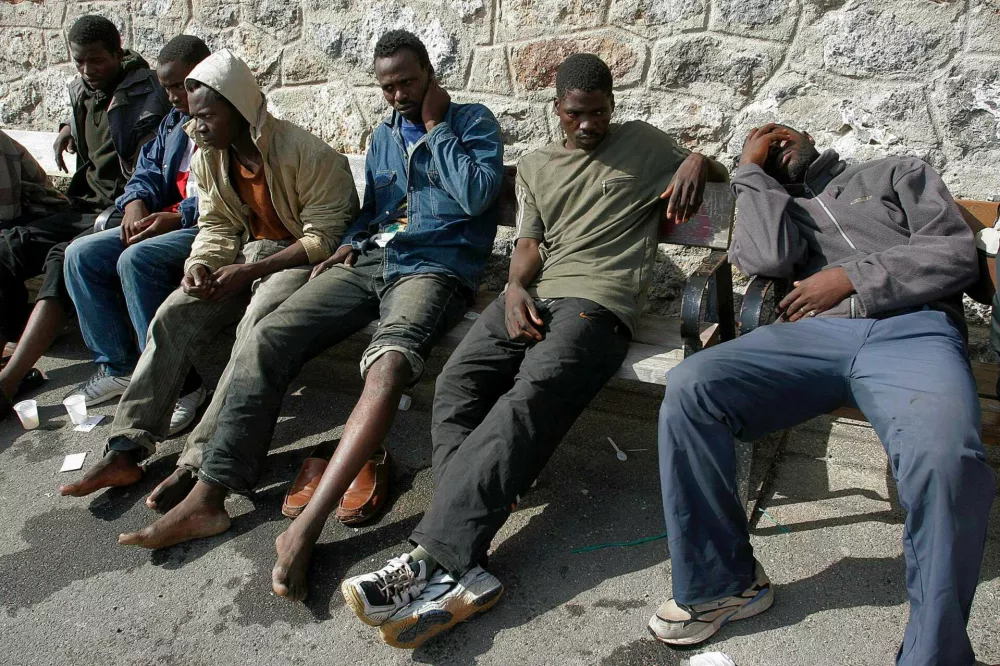 Would-be immigrants rest after they were intercepted off Spain's Almeria, June 19, 2006. Some 33 would-be immigrants were intercepted aboard a fishing boat on their way to reach European soil from Africa. REUTERS/Francisco Bonilla (SPAIN)