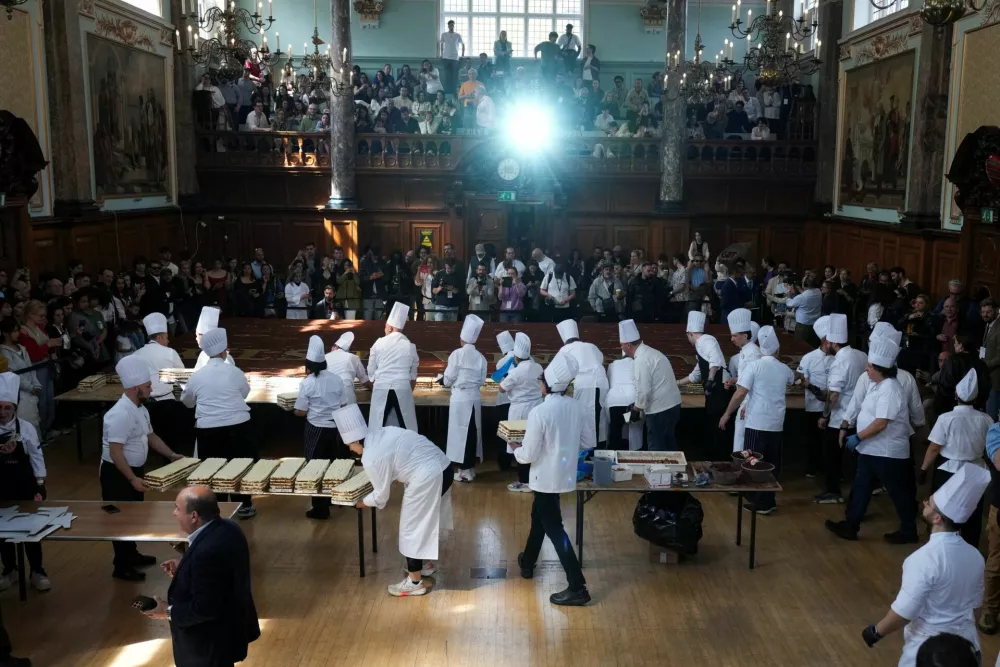 Chefs and volunteers prepare for their attempt to break the Guinness World Record for the longest tiramisu, with the expected dessert length of more than 300 metres, in London, Britain, April 26, 2026. REUTERS/Carlos Jasso