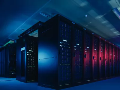 Shot of Data Center With Multiple Rows of Fully Operational Server Racks. Modern Telecommunications, Cloud Computing, Artificial Intelligence, Database, Supercomputer Technology Concept. Shot in Dark with Neon Blue, Pink Lights.