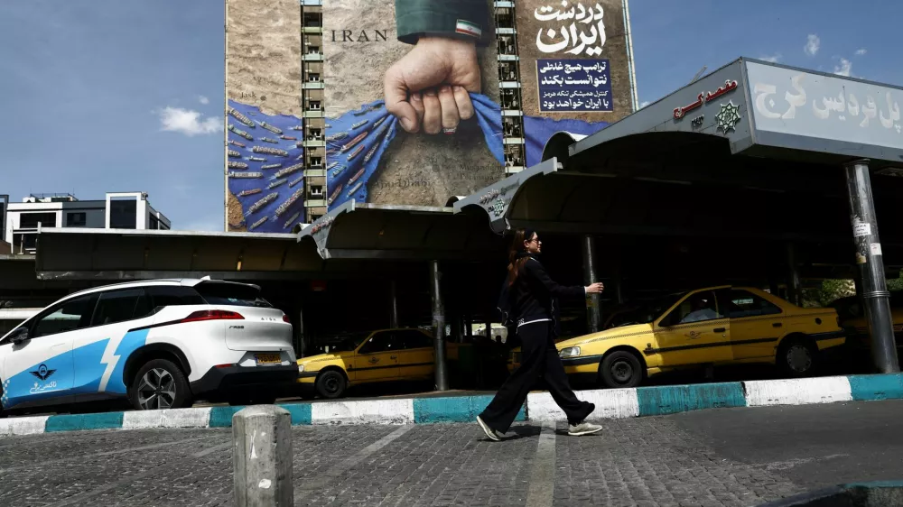 A woman walks past a billboard with a graphic design about the Strait of Hormuz on a building, amid a ceasefire between U.S. and Iran, in Tehran, Iran, April 27, 2026. Majid Asgaripour/WANA (West Asia News Agency) via REUTERS ATTENTION EDITORS - THIS PICTURE WAS PROVIDED BY A THIRD PARTY