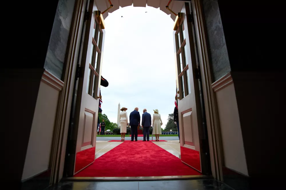 President Donald Trump and first lady Melania Trump stand with Britain's King Charles III and Queen Camilla, as seen from the Diplomatic Reception Room, during a State Visit arrival ceremony on the South Lawn of the White House, Tuesday, April 28, 2026, in Washington. (AP Photo/Jacquelyn Martin)