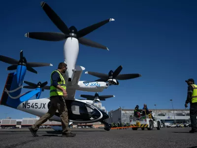 Airport employees move an electric vertical take-off and landing (eVTOL) aircraft by Joby Aviation at the John F. Kennedy International Airport, Monday, April 27, 2026, in New York. (AP Photo/Yuki Iwamura)