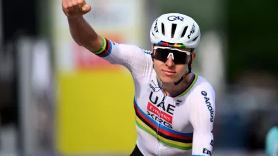 Tadej Pogacar from Slovenia raises his arms after crossing the finish line to win the first stage, a 170,6 km race around Martigny, at the 79th Tour de Romandie cycling race, in Saint-Maurice, Switzerland, Wednesday, April 29, 2026. (Laurent Gillieron/Keystone via AP)