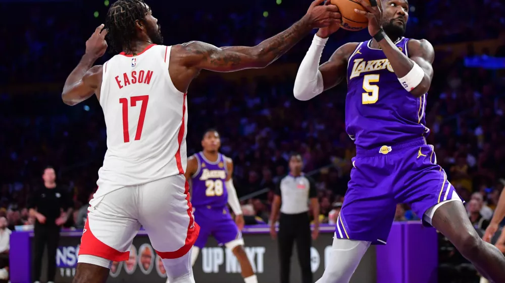 Apr 29, 2026; Los Angeles, California, USA; Houston Rockets forward Tari Eason (17) plays for the ball against Los Angeles Lakers center Deandre Ayton (5) during the first half in game five of the first round of the 2026 NBA Playoffs at Crypto.com Arena. Mandatory Credit: Gary A. Vasquez-Imagn Images
