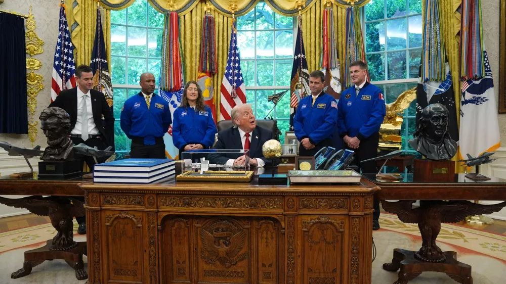 President Donald Trump speaks to reporters as he meets with NASA administrator Jared Isaacman, from left, and Artemis II astronauts Victor Glover, Christina Koch, Reid Wiseman and Jeremy Hansen in the Oval Office of the White House, Wednesday, April 29, 2026, in Washington. (AP Photo/Matt Rourke)