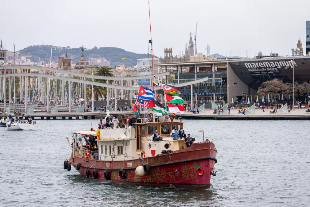 Boats carrying activists and humanitarian aid for Palestinians in Gaza reposition in the port during a symbolic send-off as part of the Global Sumud Flotilla, in Barcelona, Spain, Sunday, April 12, 2026. (AP Photo/Joan Mateu Parra)