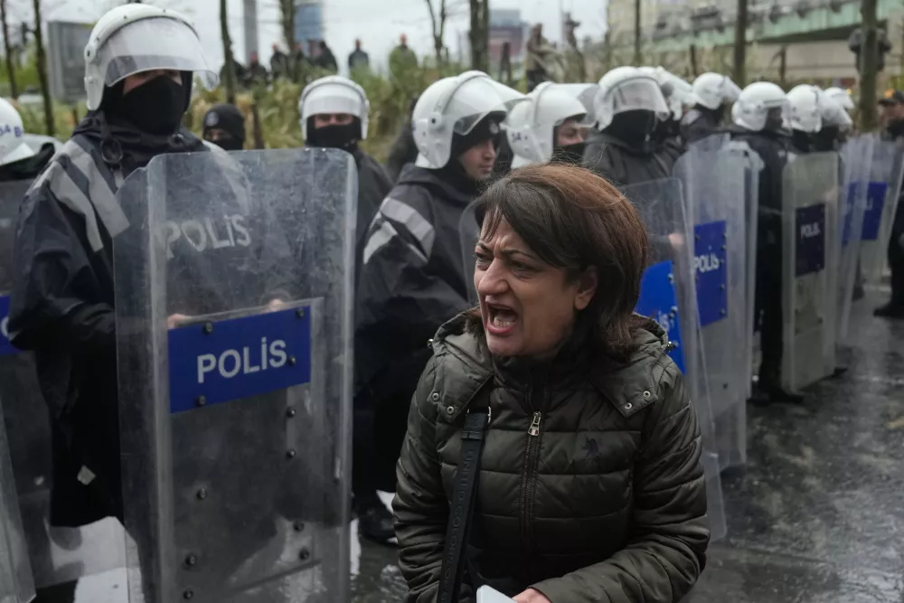 A woman shouts at Turkish police officers as union members try to march towards Taksim square in Istanbul, Turkey, Friday, May 1, 2026, during Labor Day celebrations. (AP Photo/Khalil Hamra)