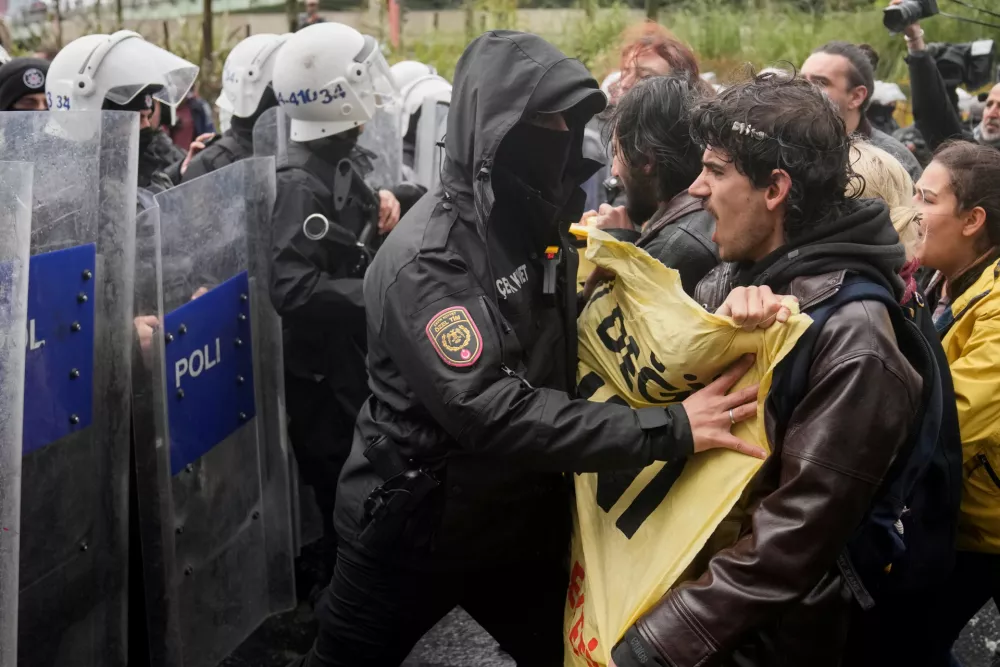 Union members scuffle with Turkish police officers as they try to march towards Taksim square in Istanbul, Turkey, Friday, May 1, 2026, during Labor Day celebrations. (AP Photo/Khalil Hamra)
