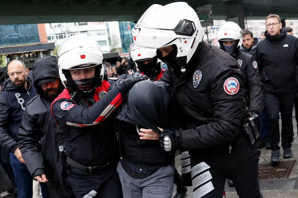 Police detain a demonstrator, as people attempt to defy a ban and march on Taksim Square to celebrate May Day, in Istanbul, Turkey, May 1, 2026. REUTERS/Kemal Aslan