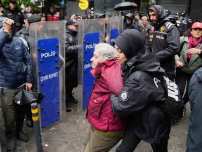 Union members are detained by Turkish police officers as they try to march towards Taksim square in Istanbul, Turkey, Friday, May 1, 2026, during Labor Day celebrations. (AP Photo/Khalil Hamra)