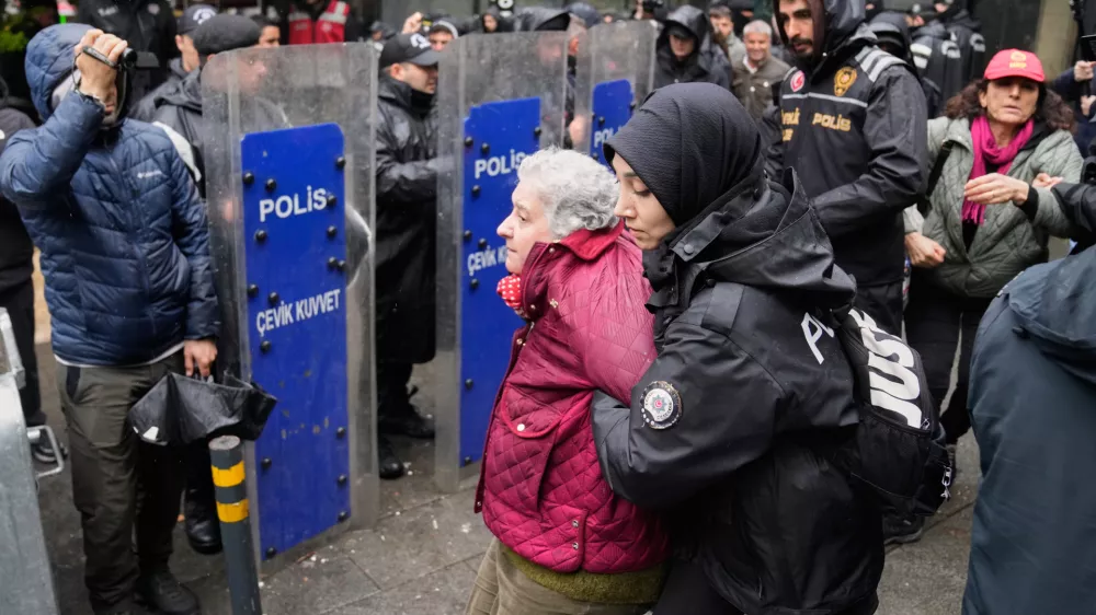 Union members are detained by Turkish police officers as they try to march towards Taksim square in Istanbul, Turkey, Friday, May 1, 2026, during Labor Day celebrations. (AP Photo/Khalil Hamra)